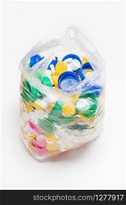bag full of plastic caps ready to be recycled. Recycling concept. Copy space