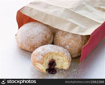 Bag Of Raspberry Jam Doughnuts With A Bite Taken