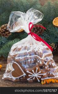 bag with christmas gingerbread cookies, fir tree border in background