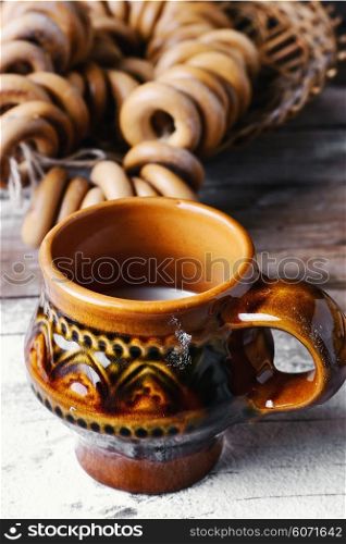 Bagels and glass of milk on background strewn with flour in the slavic style. Bagels and milk
