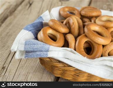 Bagels in a basket with napkin on an old wooden table