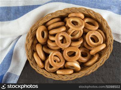 Bagels in a basket with napkin on the black table