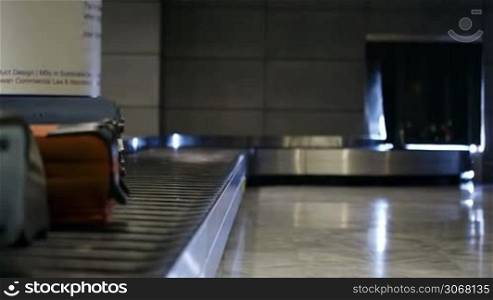 Baggage conveyor belt in the airport carrying the passenger luggage