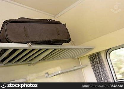 Baggage sitting on train rack in compartment travel vacation nobody