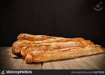 baguette on a table on dark background