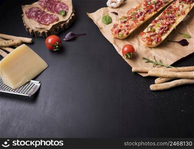 baguette pizza with italian food ingredients black stone surface