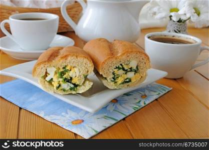 Baguette stuffed with onions and spinach with egg