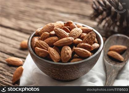 Bake almonds in a wooden bowl and placed on an old wooden floor.