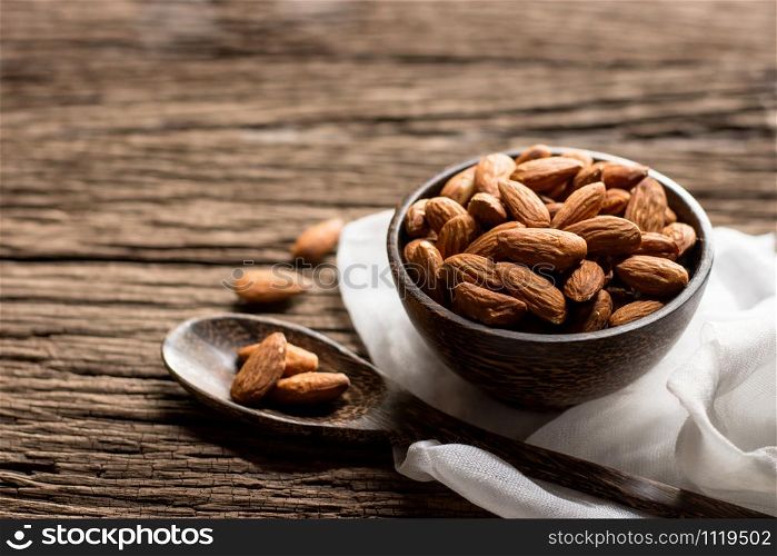 Bake almonds in a wooden bowl and placed on an old woodn floor.