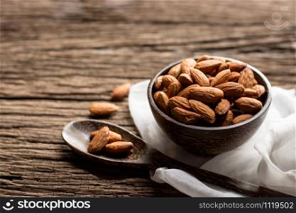 Bake almonds in a wooden bowl and placed on an old woodn floor.