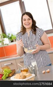 Bake - happy woman with ingredients in kitchen prepare cake