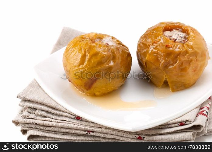 baked apples in a white plate standing on napkins