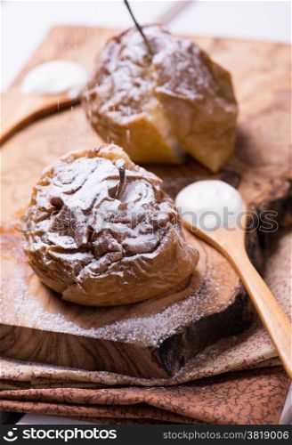 Baked apples on wooden board, selective focus