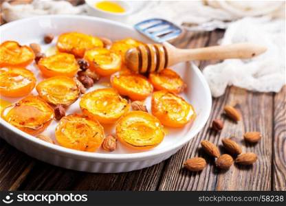 baked apricots with honey and nuts on a table