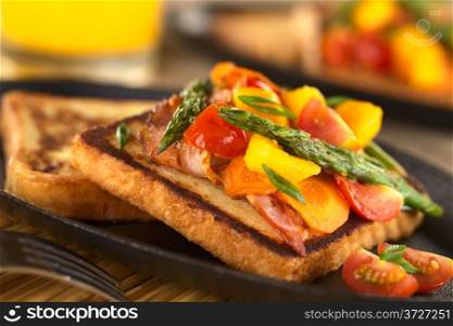 Baked asparagus, mango, tomato, carrot and bacon sandwich on wholewheat toast bread (Selective Focus, Focus on the two asparagus tips in the middle of the image). Baked Asparagus Sandwich