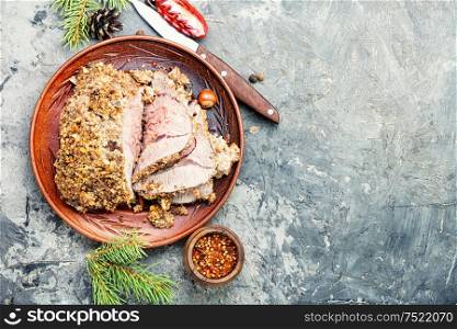 Baked beef under bread crust.Roasted beef.Space for text. Roasted sliced Christmas meat
