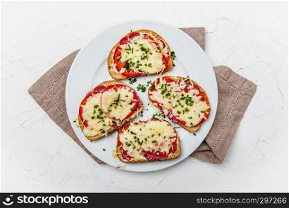 baked bread, crispy baked with salami, tomatoes and cheese, top view