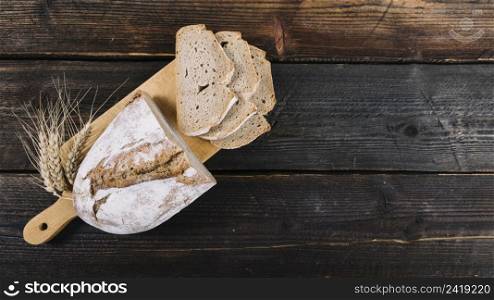 baked bread ear wheat chopping board wooden table