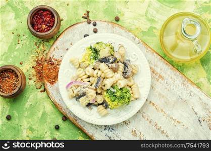 Baked broccoli and pasta with mushrooms.Italian food. Pasta with vegetables
