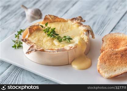 Baked Camembert cheese with toasted bread slices