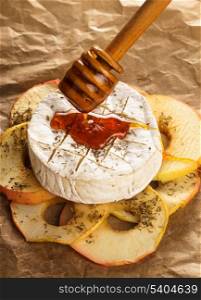 Baked camembert with apples dipped with honey and thyme