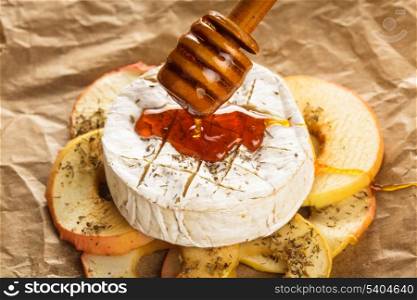 Baked camembert with apples dipped with honey and thyme