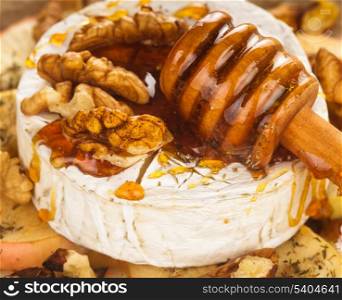 Baked camembert with apples dipped with honey and walnuts