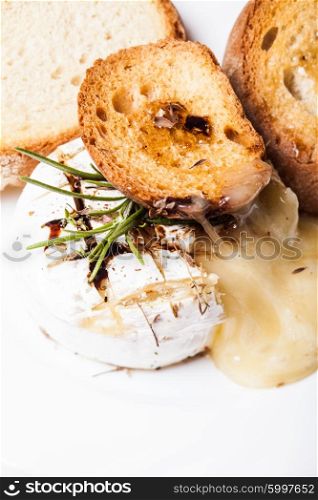 Baked camembert with herbs and spices on the pan. The Baked camembert