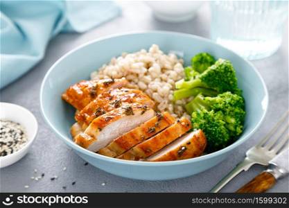 Baked chicken breast lunch bowl with pearl barley and broccoli