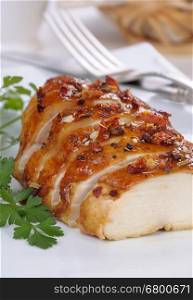 baked chicken breast sliced on a plate close-up