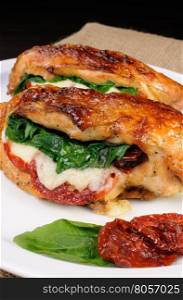 Baked chicken breast stuffed with mozzarella, spinach, sun-dried tomatoes