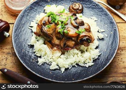 Baked chicken breast with marsala mushroom sauce and white rice.. Chicken with mushroom sauce.