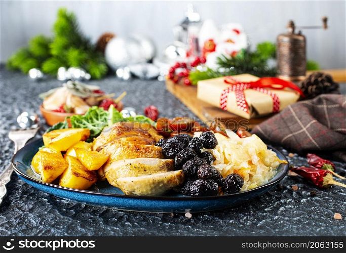 baked chicken breast with potatoes and olives on xmas background
