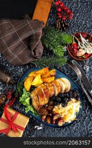baked chicken breast with potatoes and olives on xmas background