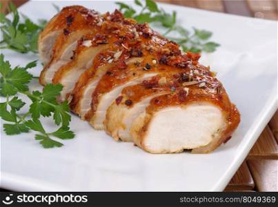 Baked chicken breast with spice sliced on a plate