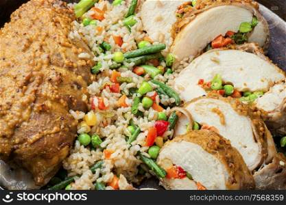 Baked chicken breast with vegetables and a side dish of risotto.Roasted chicken meat. Chicken stuffed with vegetables