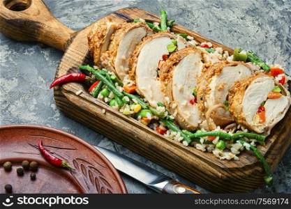 Baked chicken breast with vegetables and a side dish of risotto.Roasted chicken meat. Baked meat and risotto
