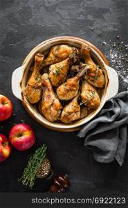 Baked chicken legs with apples. top view