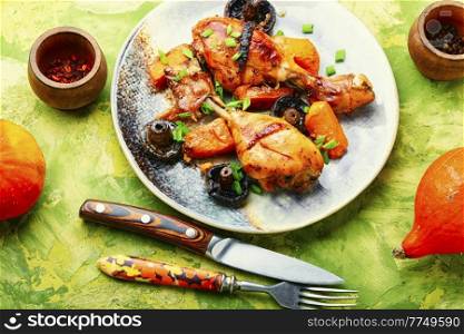 Baked chicken legs with pumpkin and mushrooms. Autumn meat recipe. Chicken legs in soy sauce with pumpkin