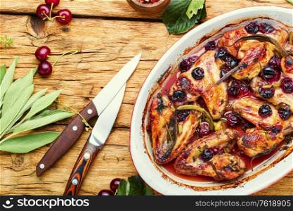 Baked chicken meat in a cherry sauce with herbs. Roasted chicken with cherry.