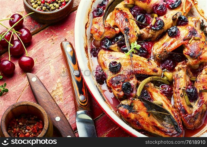 Baked chicken meat in a cherry sauce with herbs. Roasted chicken with cherry.