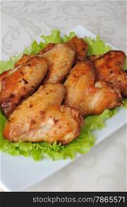 Baked chicken wings in honey and soy marinade with garlic