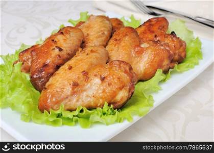 Baked chicken wings in honey and soy marinade with garlic