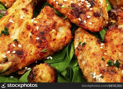 Baked chicken wings with sesame seeds. Chicken meat. Close up. Baked chicken wings.BBQ