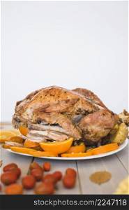 baked chicken with oranges white wall background