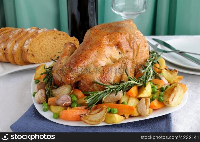 Baked chicken with vegetables and whole rosemary