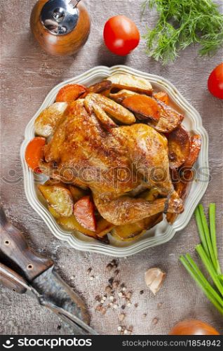 baked chicken with vegetables on metal plate