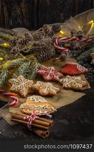 Baked Christmas cookies on rustic dark background.