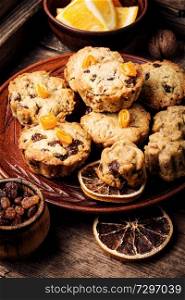 Baked cookies with raisins and orange on rustic wooden table. Cookies on wooden table