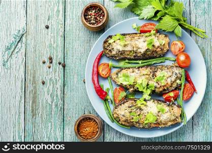 Baked eggplant stuffed with mushrooms and tomatoes. Vegetarian food.Copy space. Halved baked eggplant.